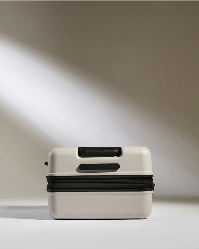a small white and black suitcase