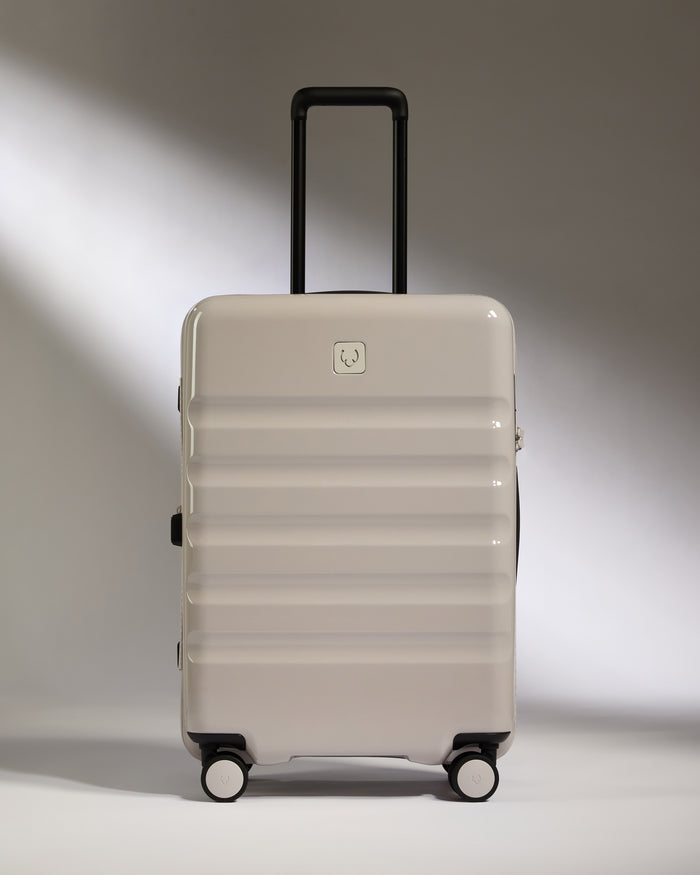 a white suitcase with black wheels