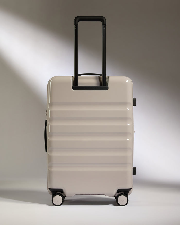 a white suitcase with black handles