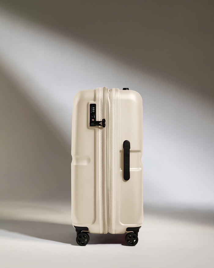 a white suitcase with black wheels