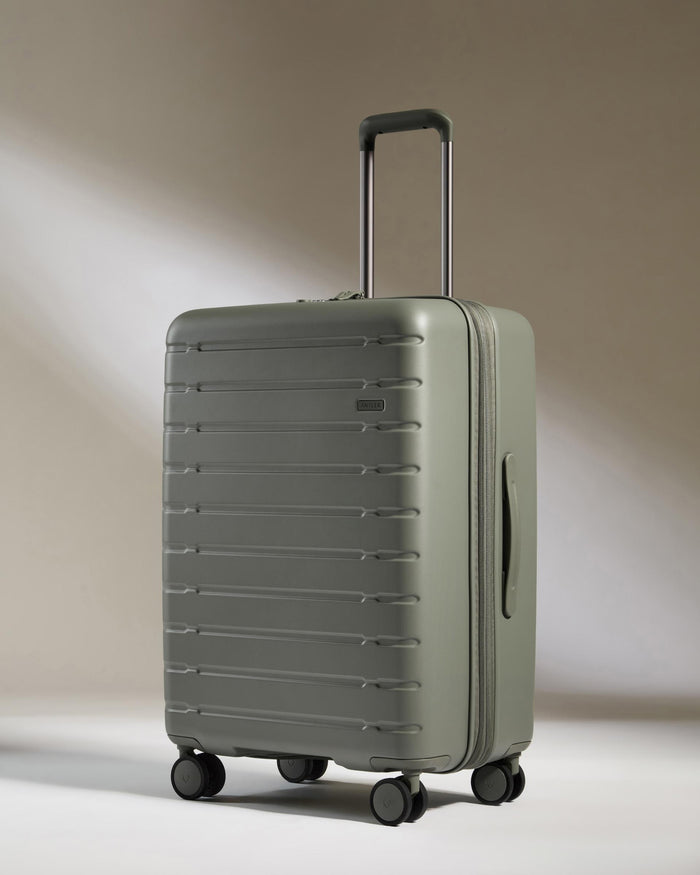 a grey suitcase with wheels