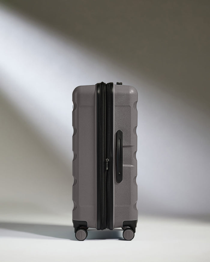 Antler Luggage -  Expandable Medium Suitcase in Gloss Gull Grey - Logo Stripe - Expanding Rollercase | Medium 4W Expandable Medium Suitcase in Gloss Gull Grey - Logo Stripe