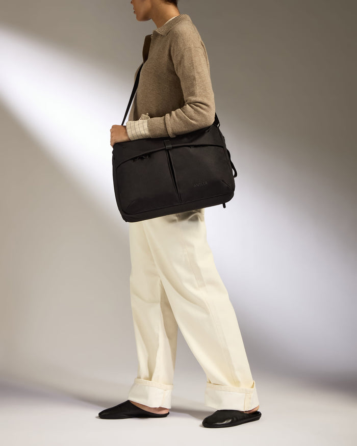 a woman holding a black bag