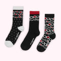 Three pairs of black Lulu Guinness socks with different designs: polka dots, linked hearts, and linked hearts with a red cuff.