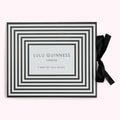Box of Lulu Guinness London socks with a black and pale green striped design and black ribbon.