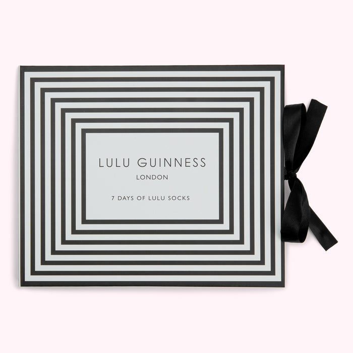 Box of Lulu Guinness London socks with a black and pale green striped design and black ribbon.