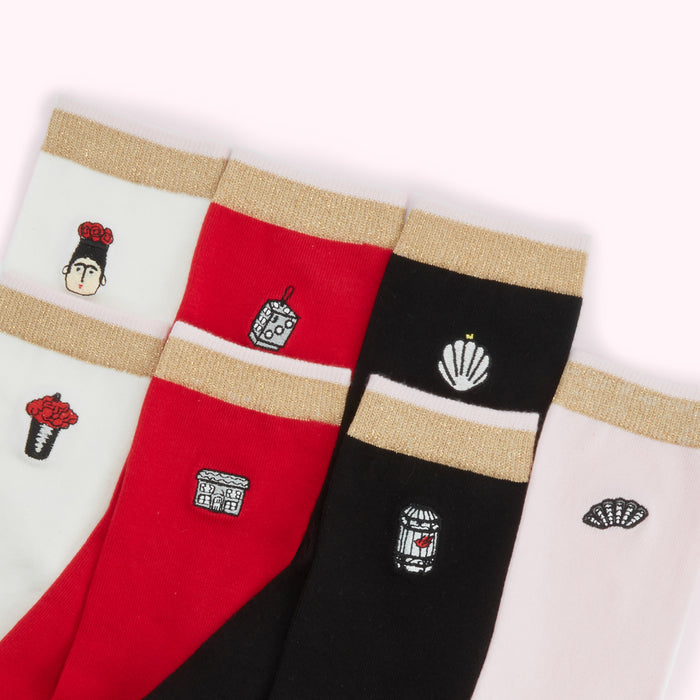 Five pairs of socks with gold accents and embroidered images. The socks are in colours of white, red, black, and pink.