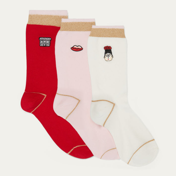 Three pairs of socks in red, pink, and white with decorative elements on a light gray background.