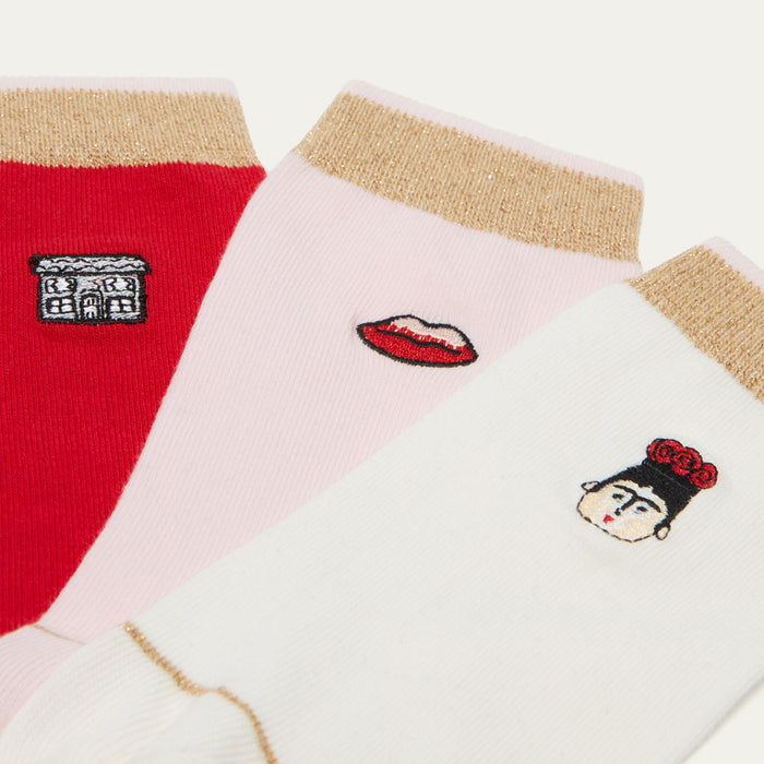 Colorful socks with embroidered designs on a white background