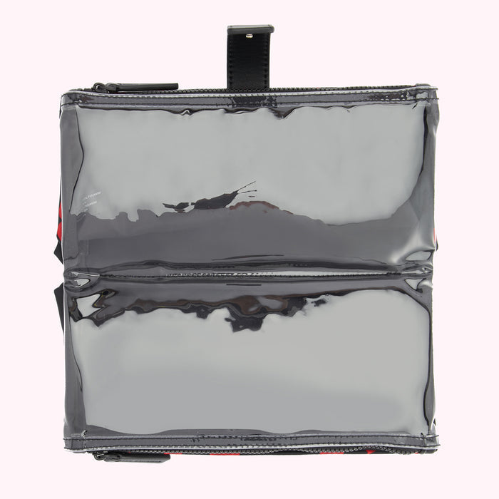 Overhead view of a clear, black, zippered pouch with a black leather handle.