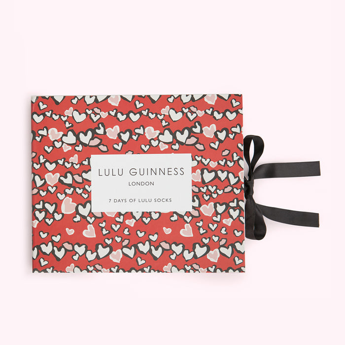 Red box with black ribbon, 7 pairs of Lulu Guinness socks, hearts pattern.