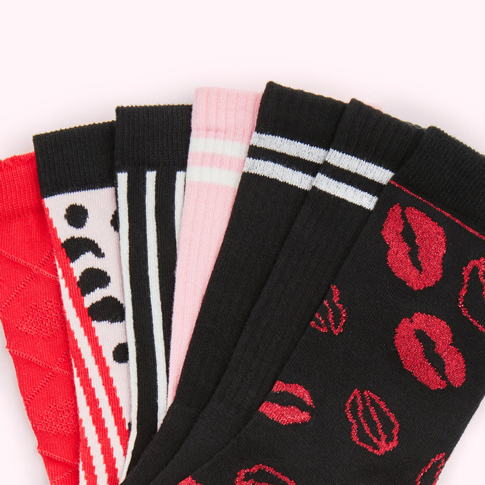 Five pairs of socks in various patterns and colours; red, black, white, and pink.