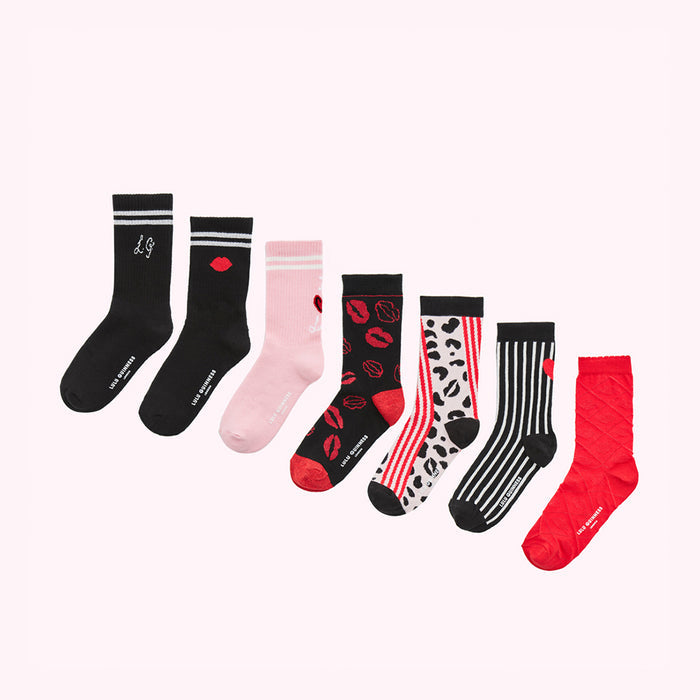 Seven pairs of women's socks in various Valentine's Day themed designs on a white background.