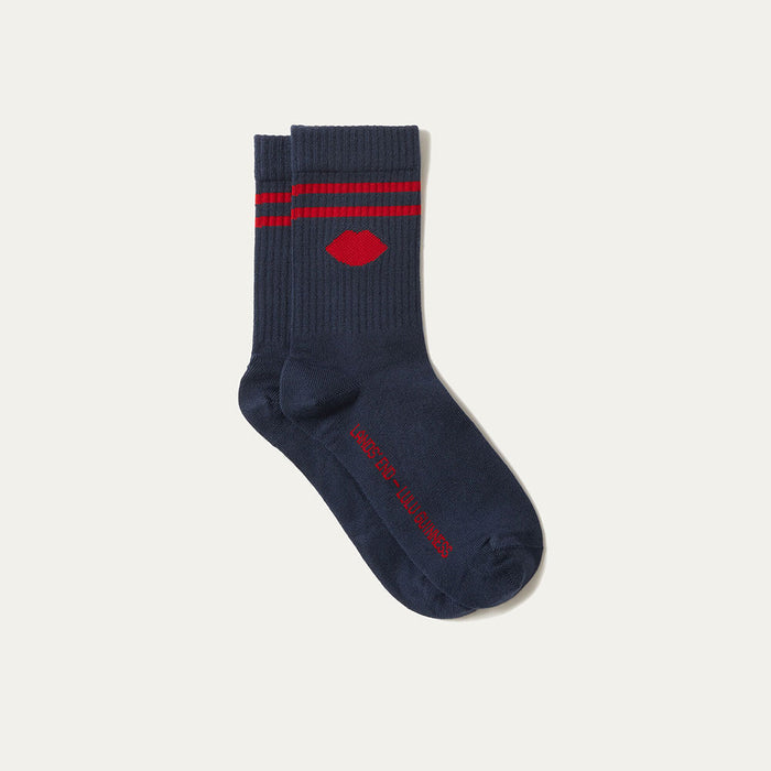 Navy sock with red stripes and logo on a light gray background