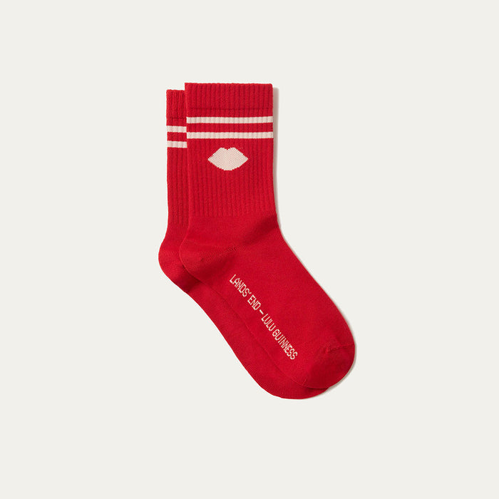 Red sock with white stripes and text on a light gray background