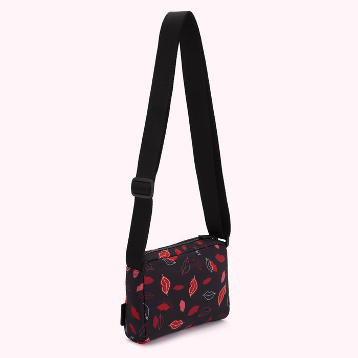 Black crossbody bag with a red and pink lips pattern.