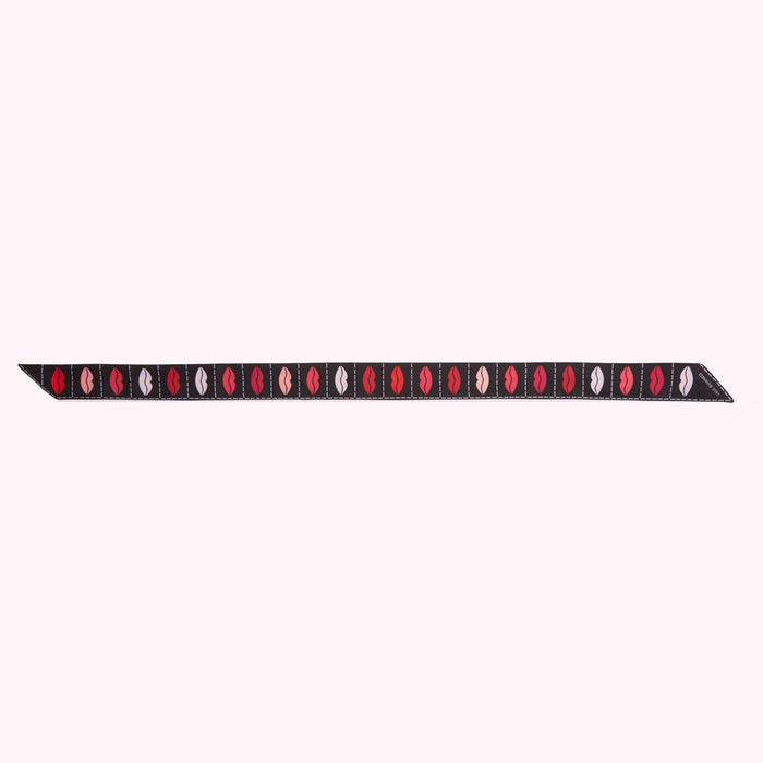 Black ribbon with a repeating pattern of multi-coloured lips.