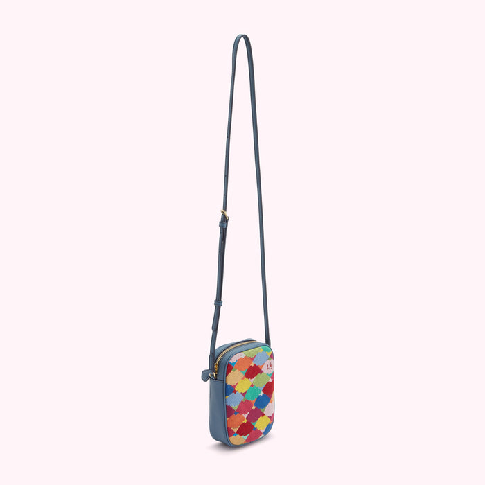 Blue crossbody bag with a multi-coloured geometric patterned front flap.