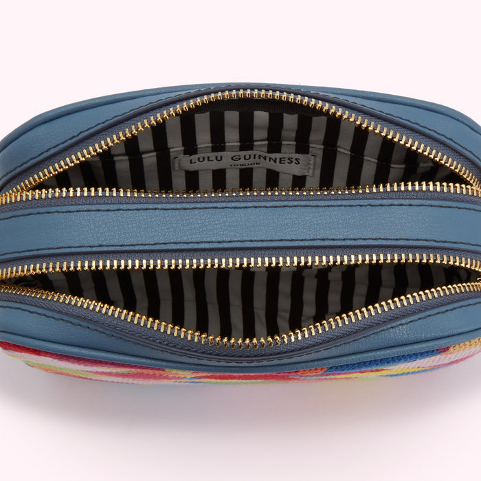 Inside of a Lulu Guinness London handbag with two compartments and a striped interior.
