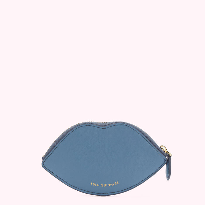 A blue leather Lulu Guinness lip-shaped zip purse against a white background.