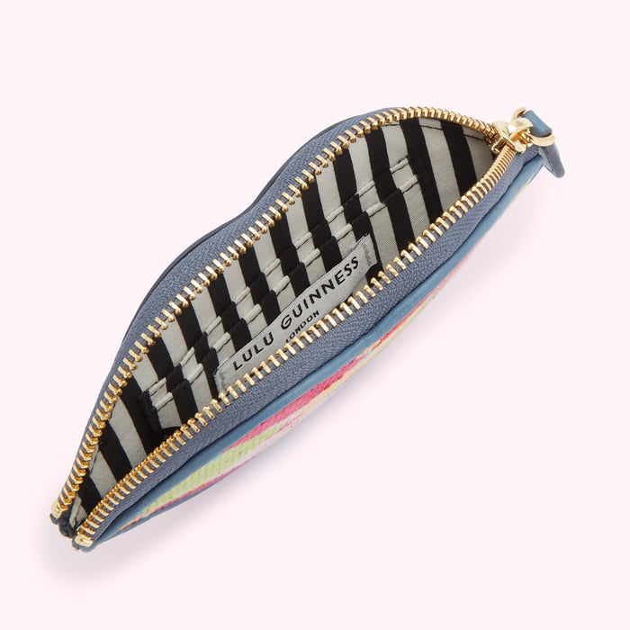 Open blue lip-shaped coin purse with black and white striped interior; Lulu Guinness London label visible.