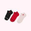 Three pairs of ankle socks in black, red, and pink with small red hearts on each sock.