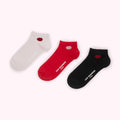 Three pairs of Lulu Guinness ankle socks in white, red, and black, each with a small lip-shaped design.