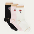 Three pairs of socks with embroidered designs on a light gray background