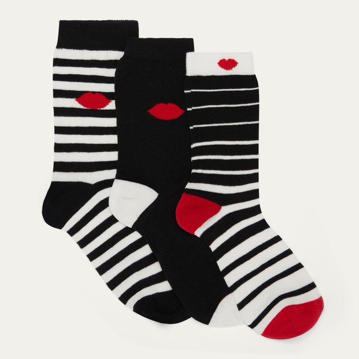 Three pairs of black, white, and red striped socks with lip designs on a light gray background.
