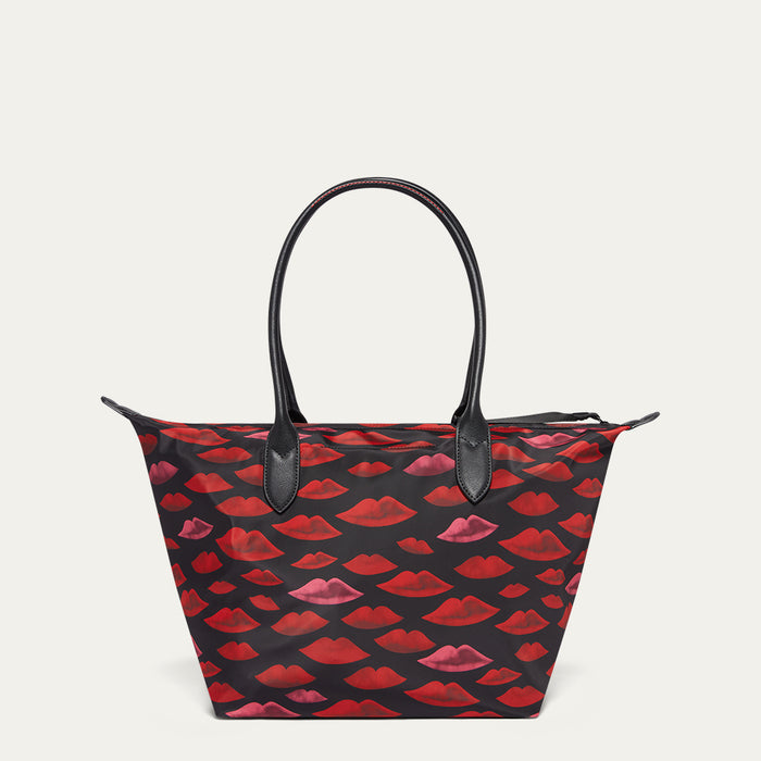 Tote bag with red lip pattern on a light gray background