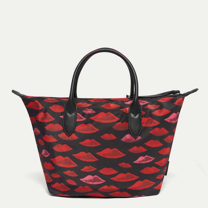 Tote bag with red and pink lip pattern  on a beige background