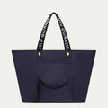 Navy tote bag with black handles featuring 'Lulu Guinness' on a light grey background