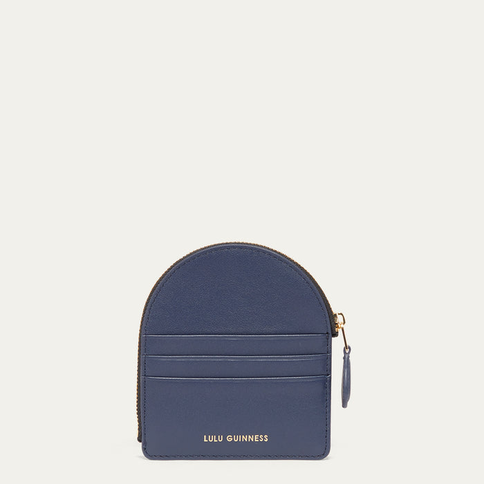 Blue coin purse with gold zipper on a light gray background