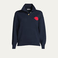Navy sweater with a red lip on the front  and button up collar on a light gray background