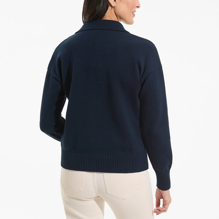 Person wearing a navy sweater on a white background