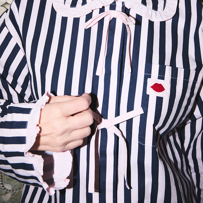 Navy and pale pink striped pyjama shirt with a red lip design on a white background