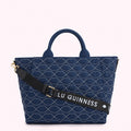 Navy blue quilted tote bag with a repeating lip pattern and a black adjustable strap with "Lulu Guinness" printed on it.