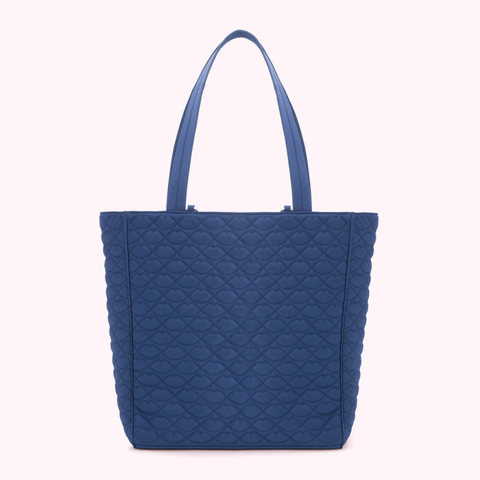 A blue quilted tote bag with a lip print pattern.