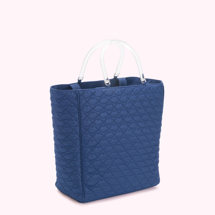 Blue quilted tote bag with clear handles.