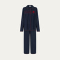 Navy pajama set with red accents on a light gray background