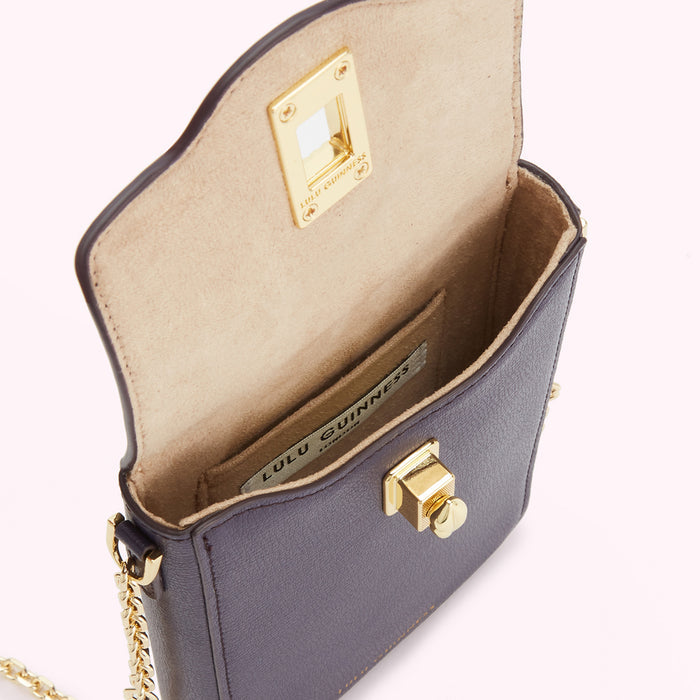 Open purple Lulu Guinness crossbody bag with gold hardware and beige interior.