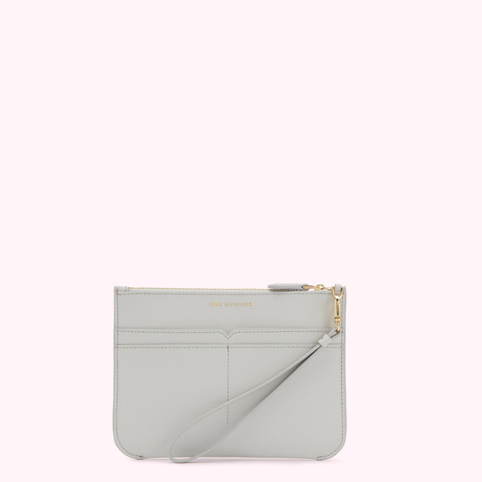 Light grey leather clutch with gold zipper and wrist strap. The brand name LULU GUINNESS is subtly embossed on the front.