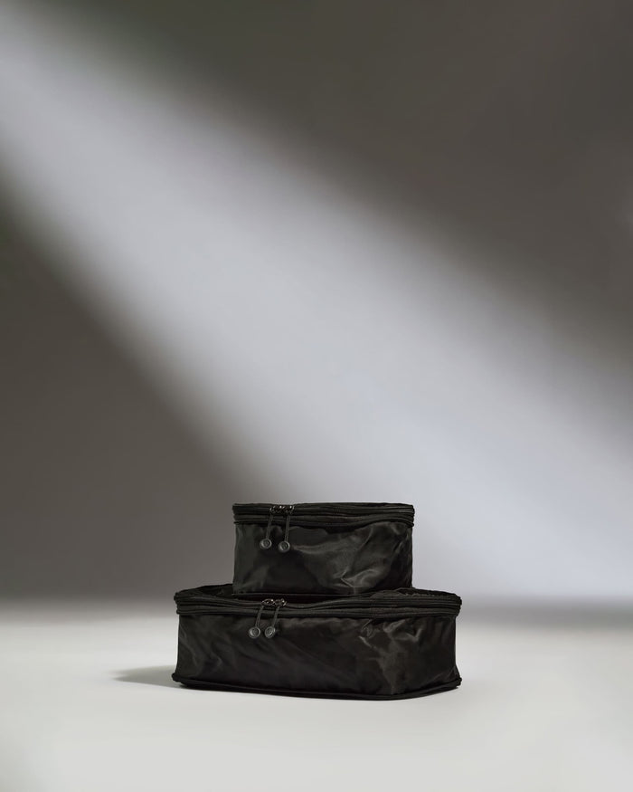 a black bags stacked on top of each other