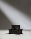 a black bags stacked on top of each other