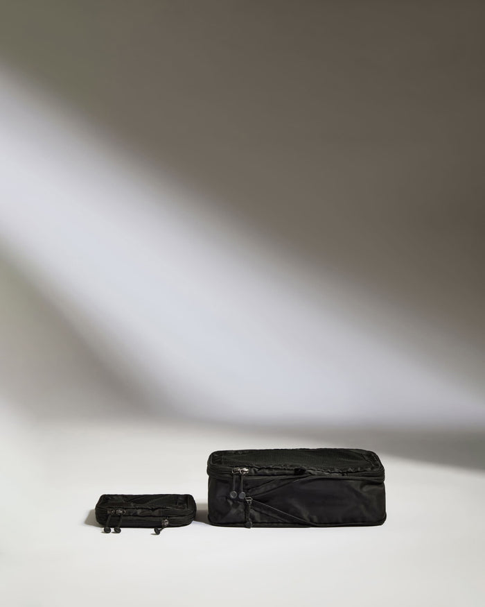 a black suitcases on a white surface