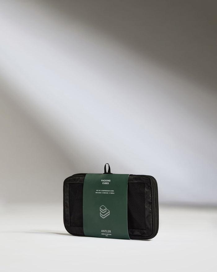 a black and green bag with a green label