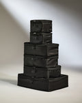 a stack of black luggage bags