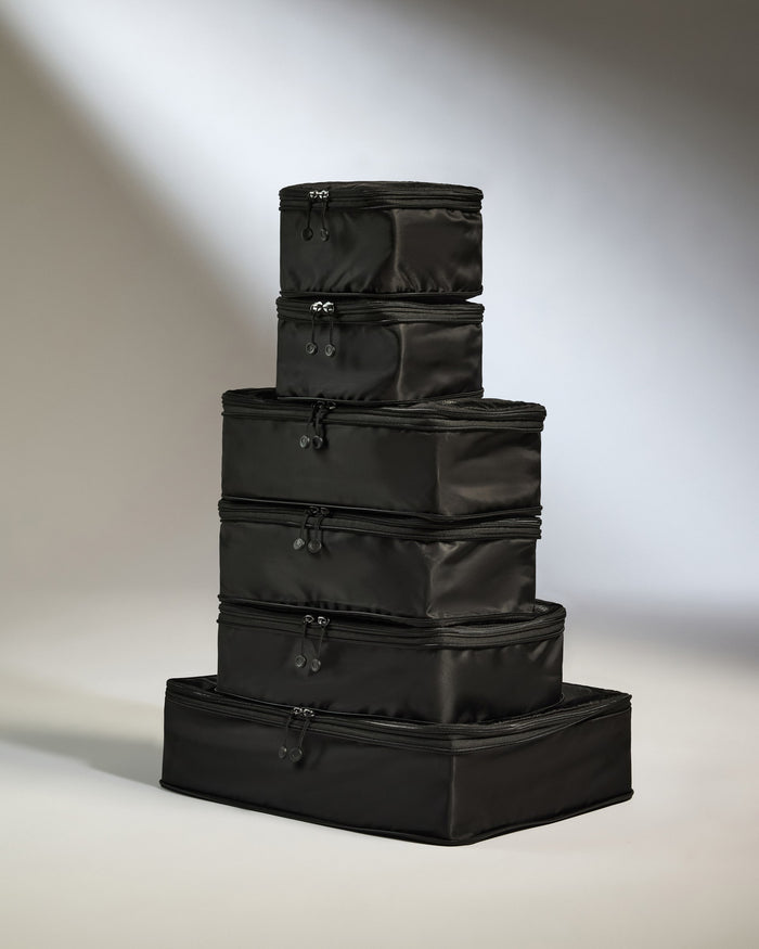 a stack of black luggage bags