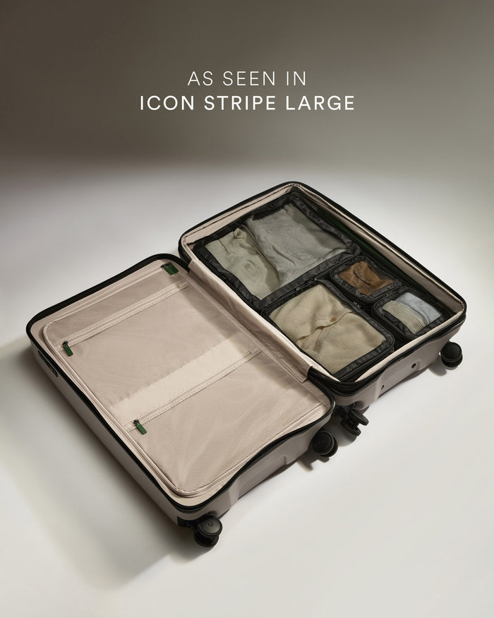 a suitcase with wheels and a few pieces of fabric