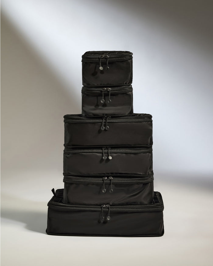 a stack of black luggage